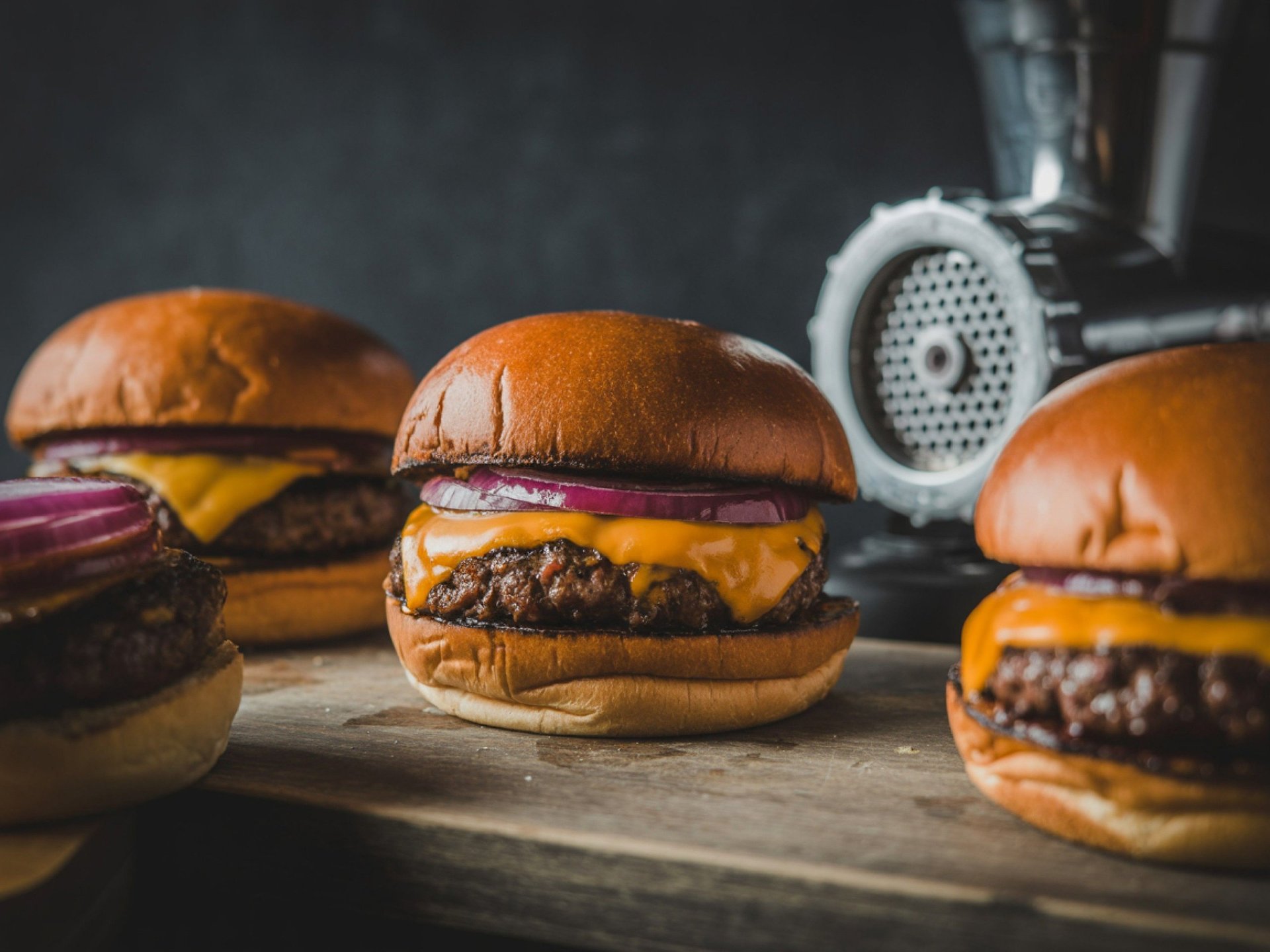Delicious cheeseburgers with melted cheese and onions